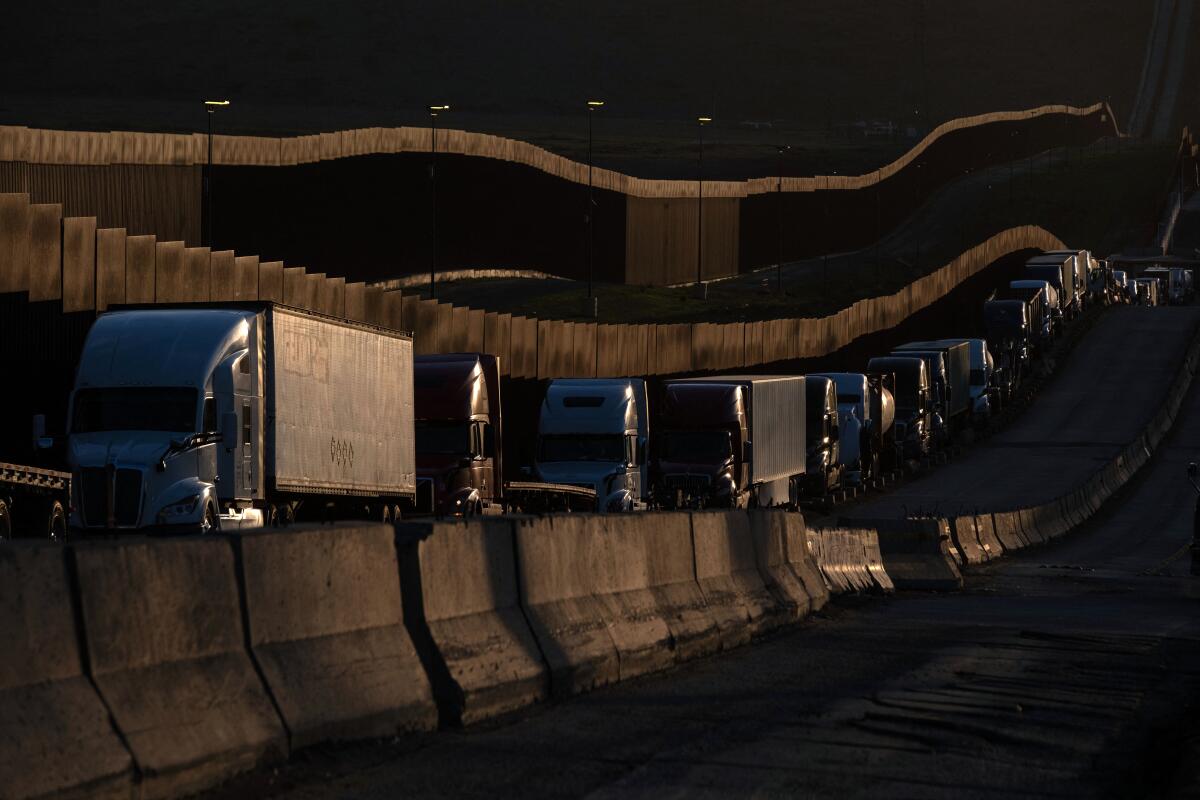 Trucks queue near the Mexico-US border before crossing the border at Otay Commercial crossing in Tijuana