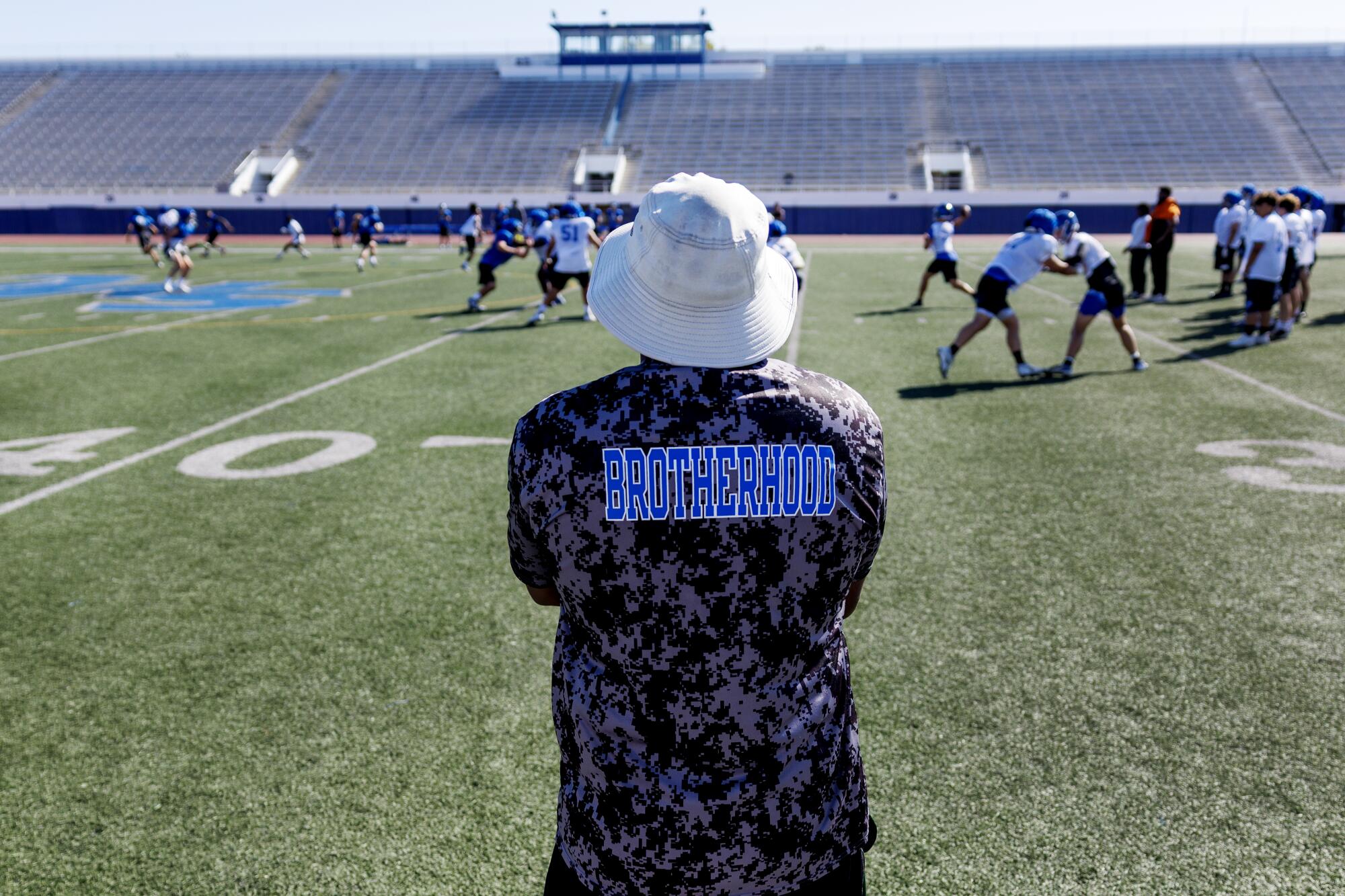 Pali High head football coach Dylen Smith watches practice from the sidelines at Santa Monica College.