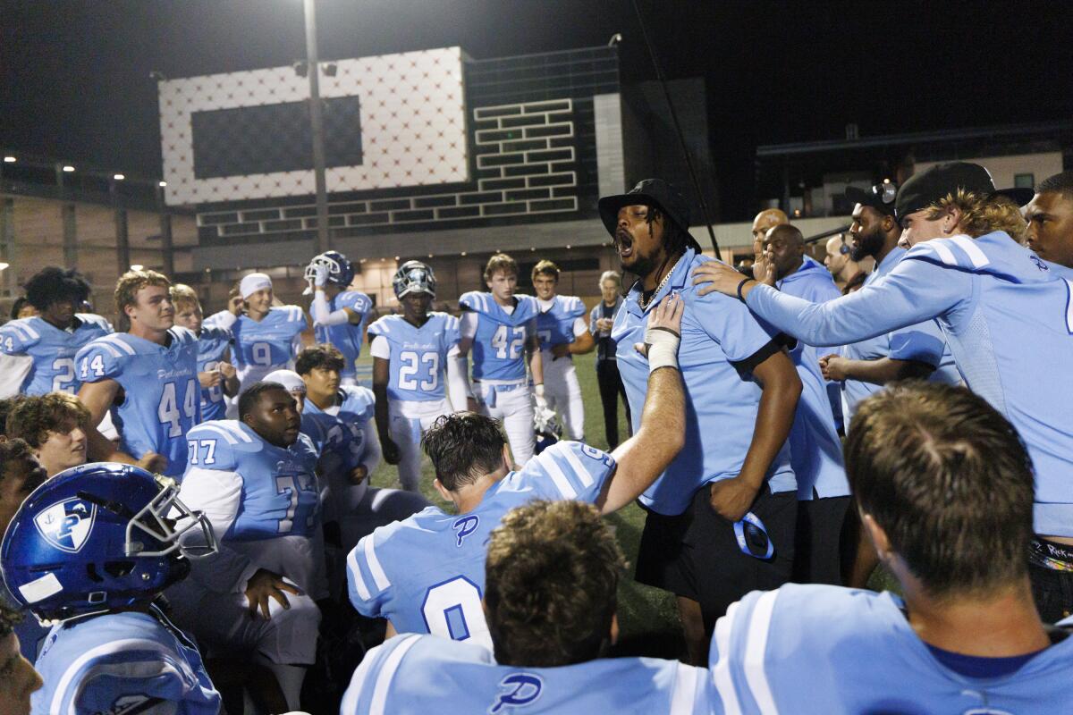 Pali High DB Coach Donte Dezeurn congratulates his team after their victory.