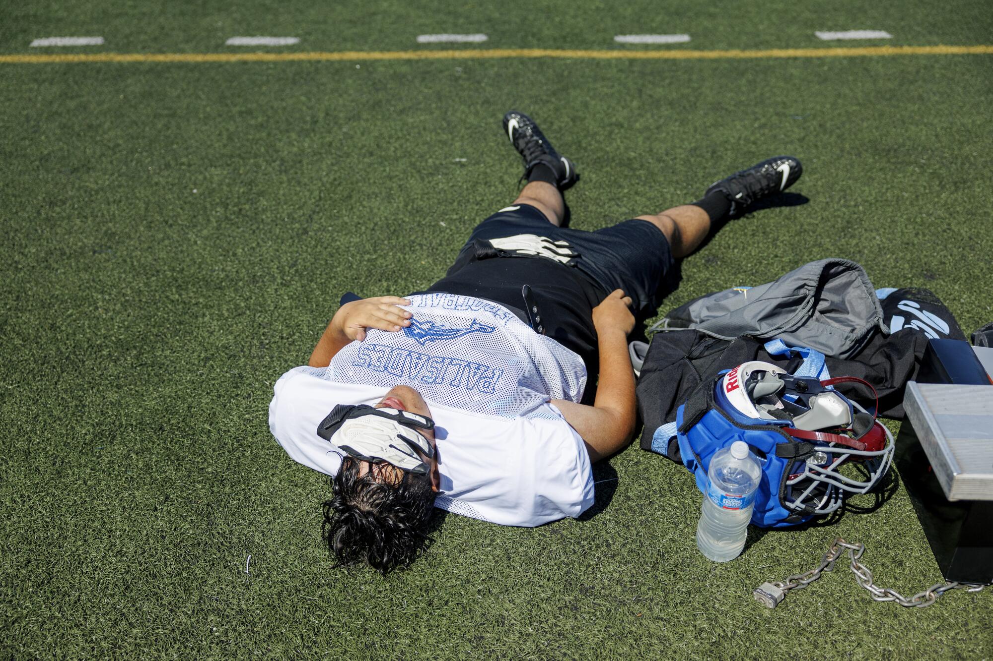 Pali High offensive lineman Iliya Heydarkhanie takes a break during practice at Santa Monica College.