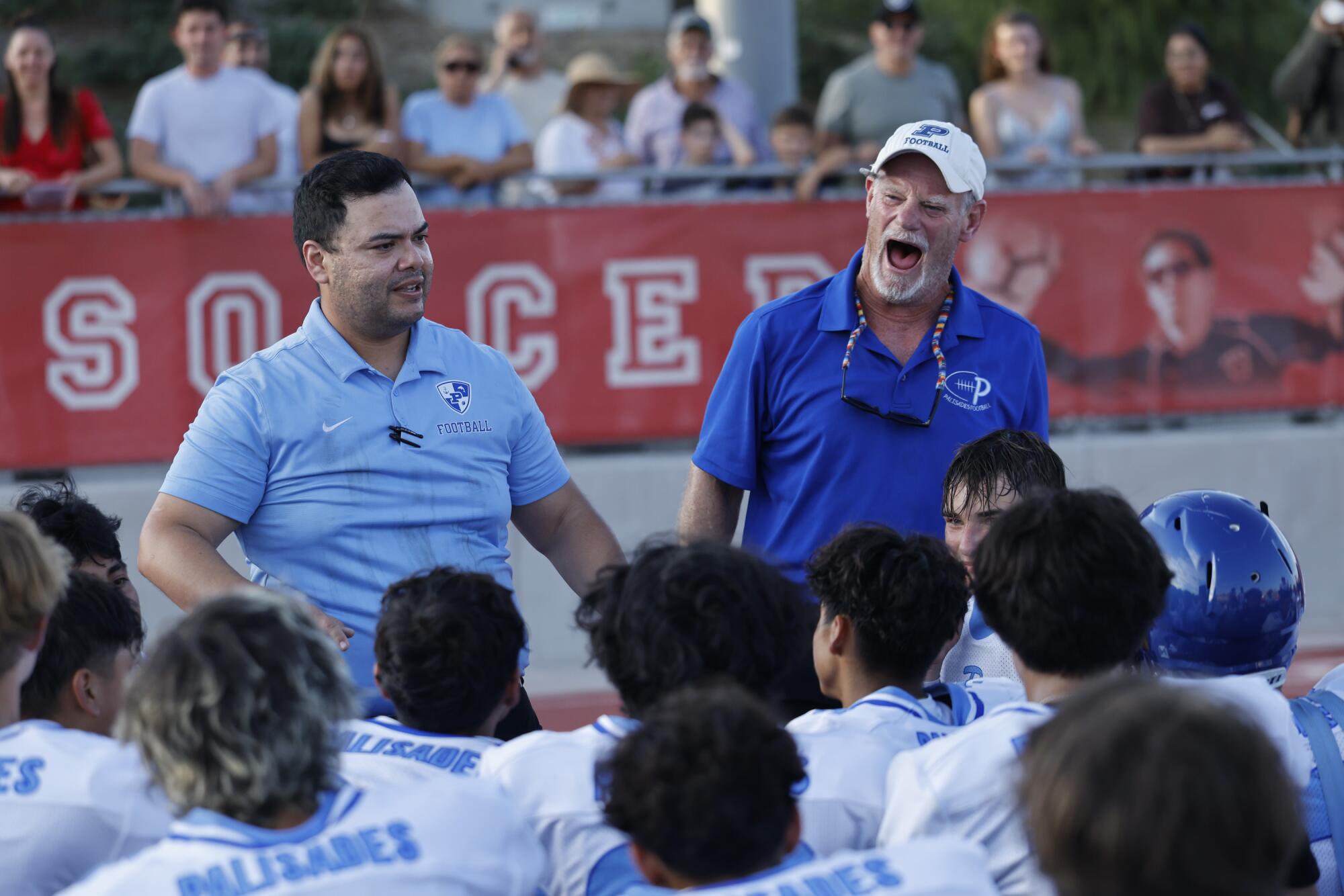 Pali High JV head coach Reynaldo Padilla, left, and Kelly Loftus, the team's defensive coordinator, give a victory speech.