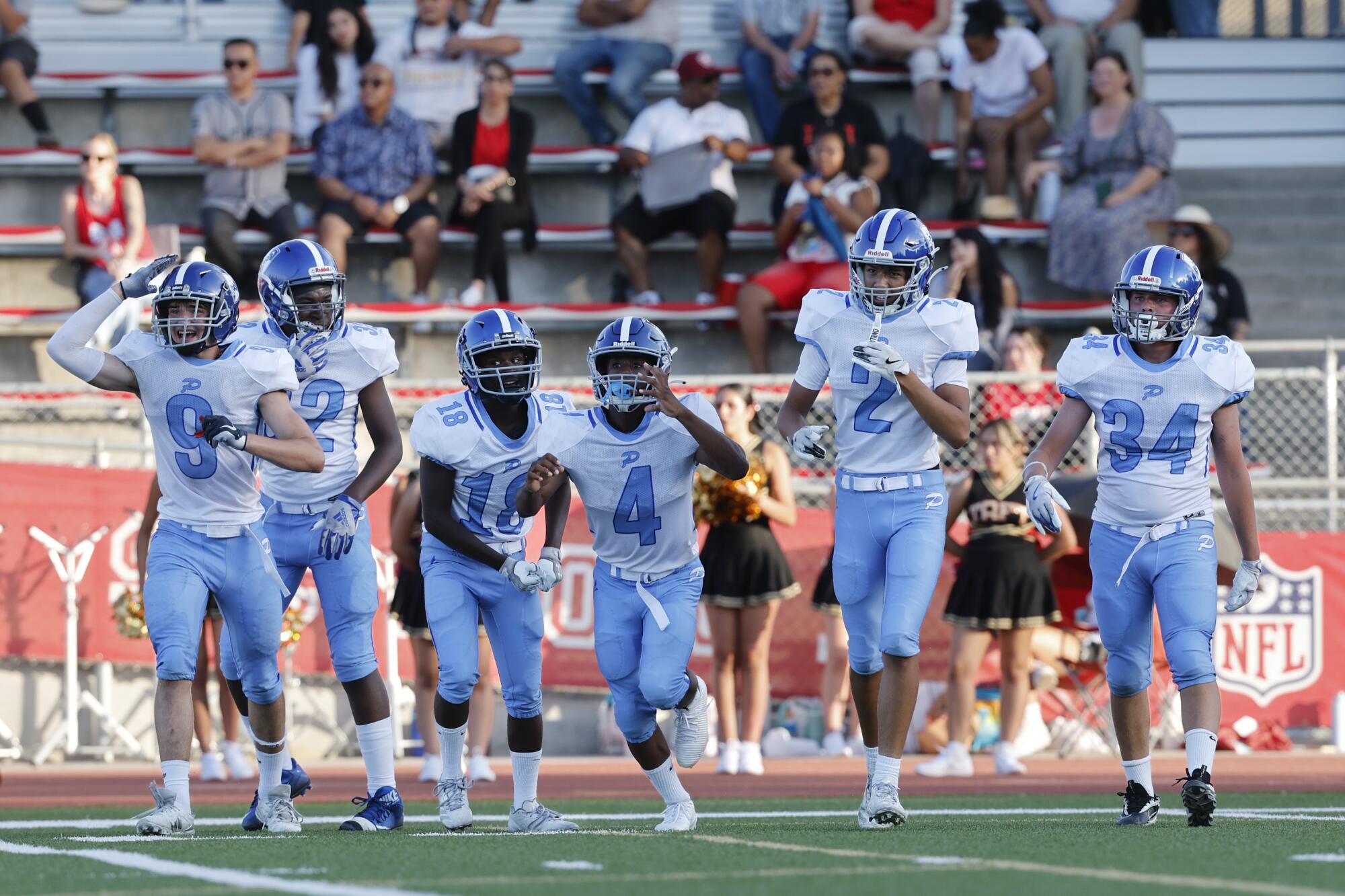 Pali High players celebrate a turnover during the JV football game against Taft High School.