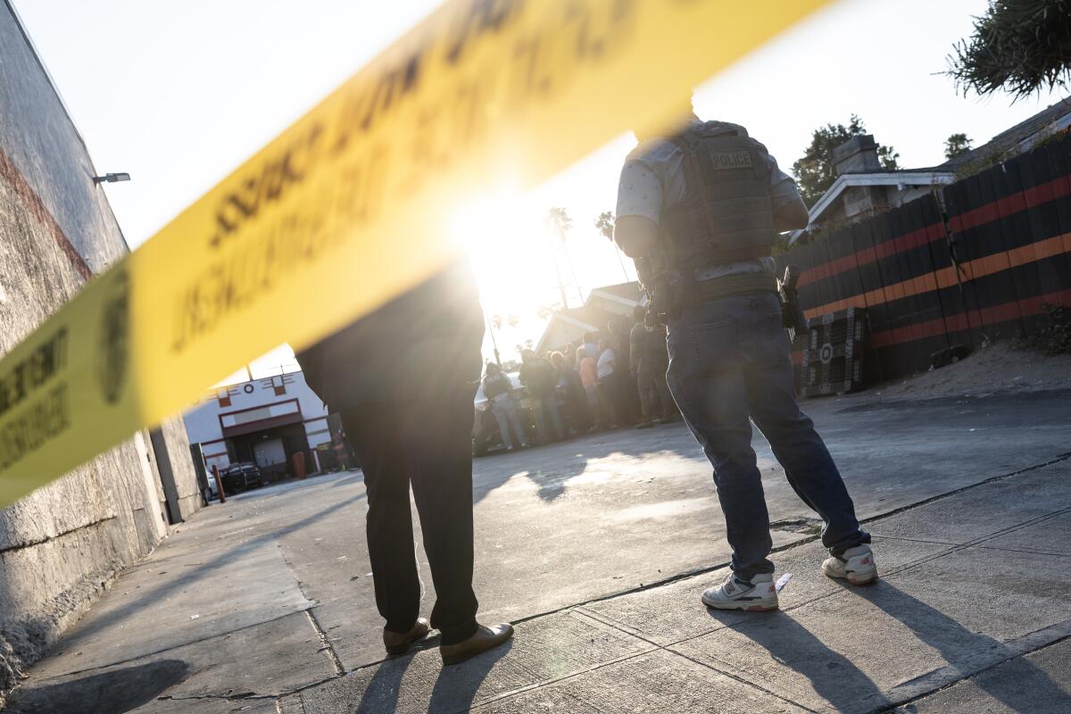 LAPD officers standing near police tape