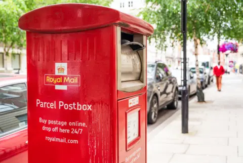 Getty Images A red Royal Mail postbox. It reads: 'Parcel postbox. Buy postage online, drop off here 24/7. royalmail.com'