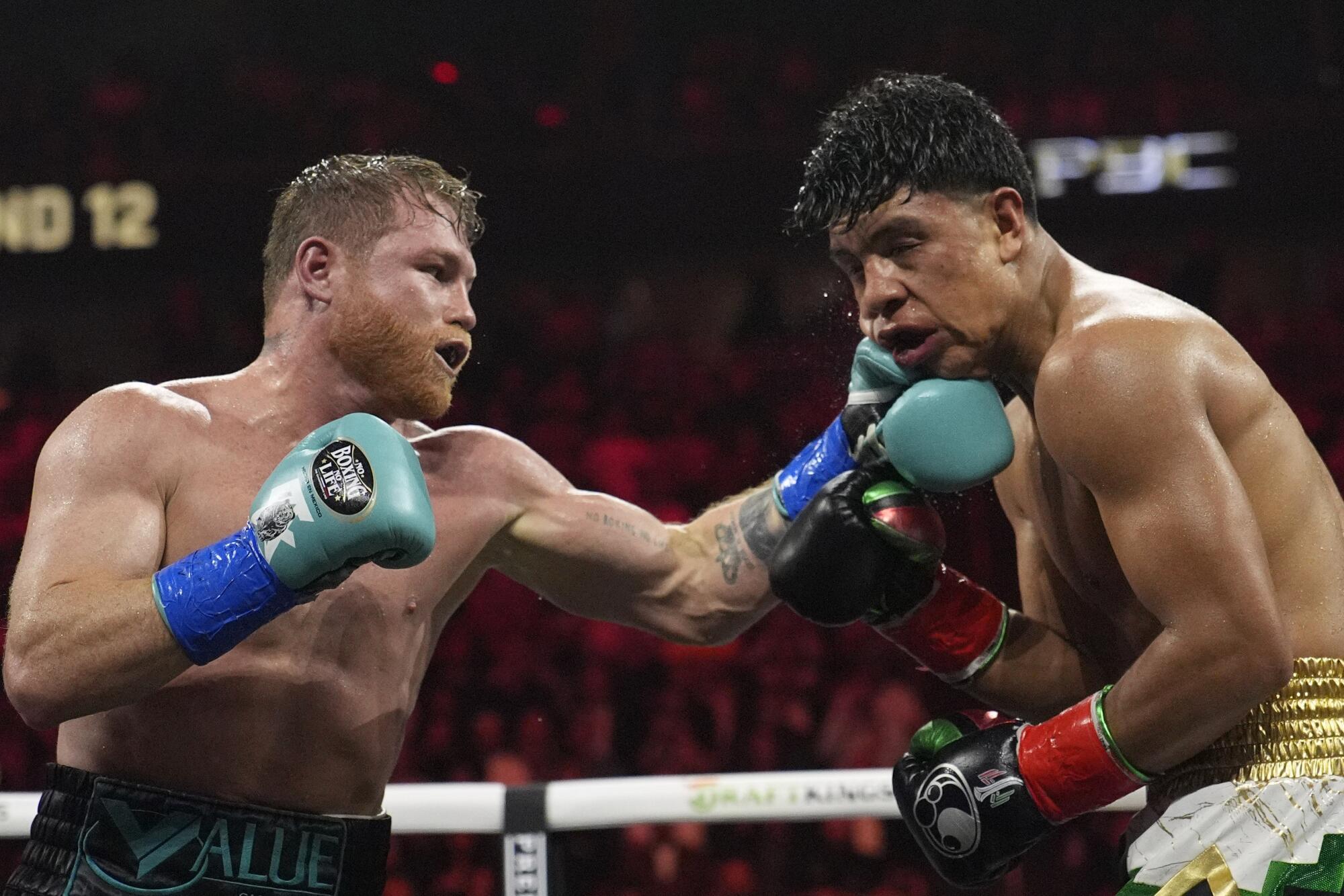 Canelo Alvarez hits Jaime Munguia during a super middleweight title fight on May 4, 2024, in Las Vegas. 