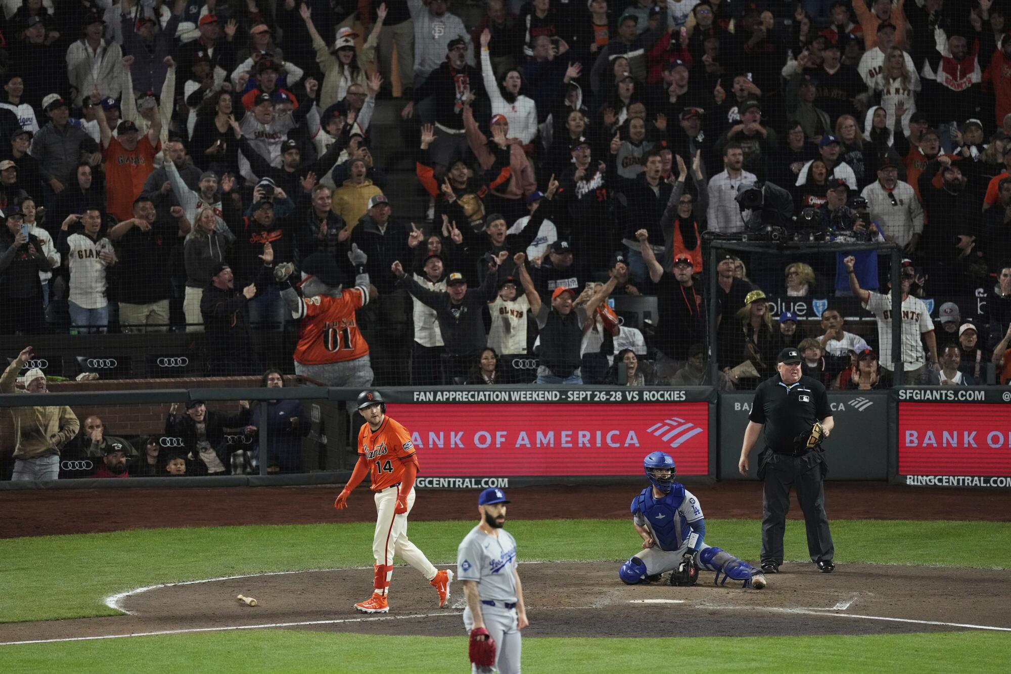 Dodgers closer Tanner Scott, foreground, watches a game-wining grand slam hit by the Giants' Patrick Bailey (background).