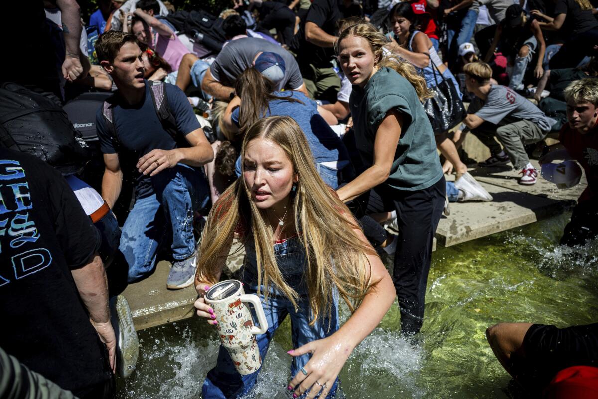 Audience members scramble away after the shooting.