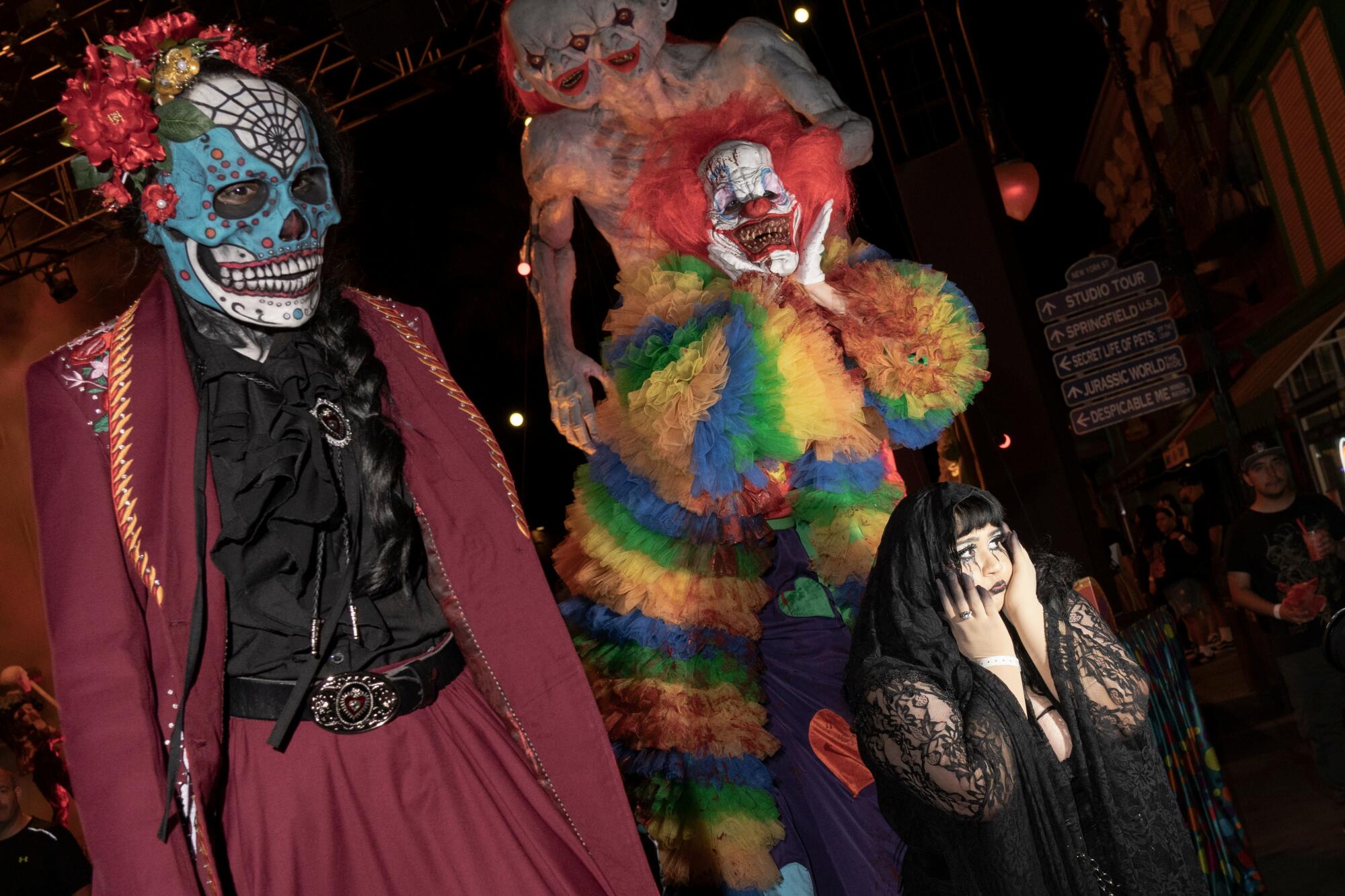 A pair of actors in Día de Muertos and clown makeup.