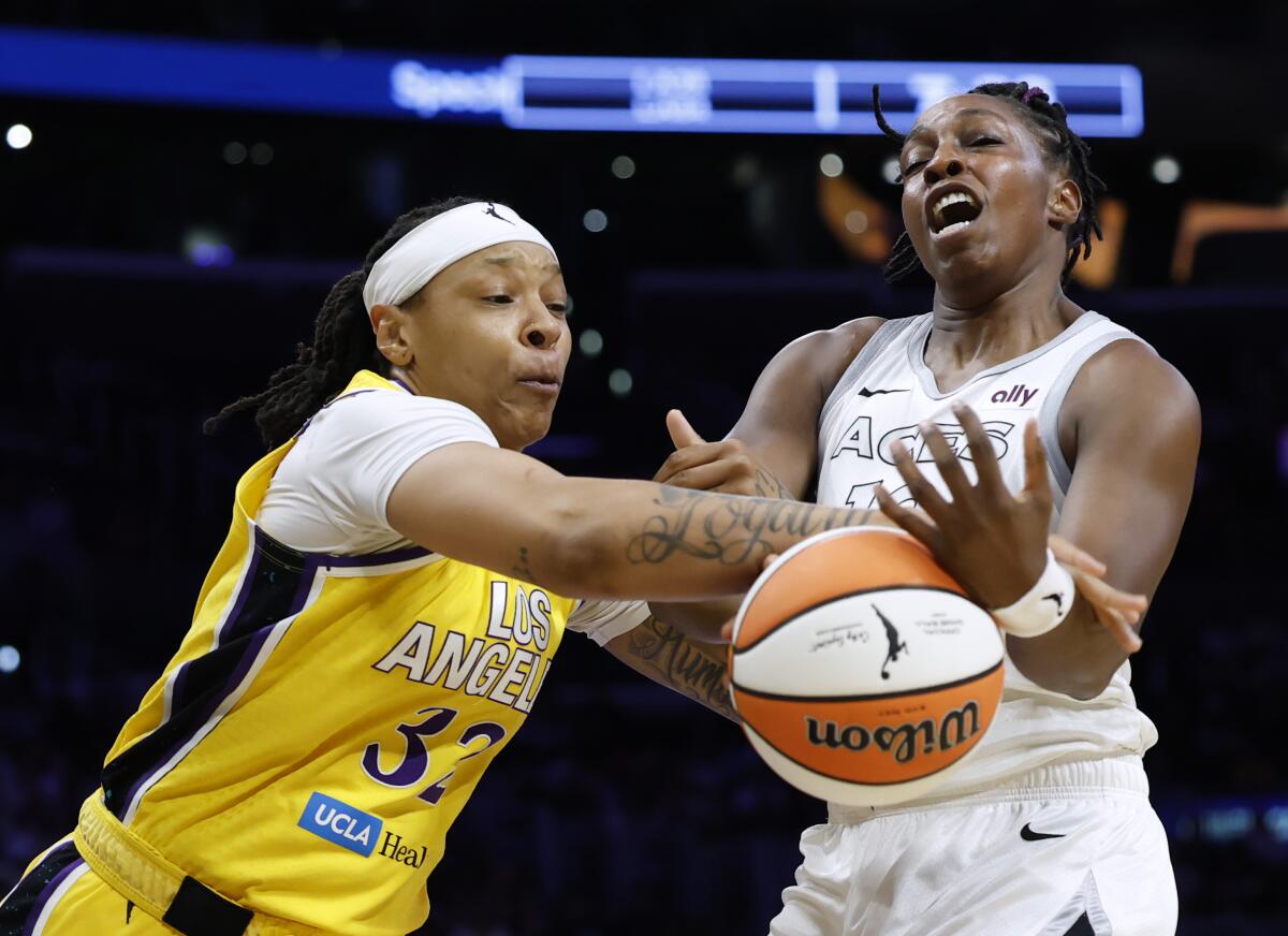 Sparks forward Emma Cannon, left, knocks the ball out of the hands of Las Vegas guard Chelsea Gray.