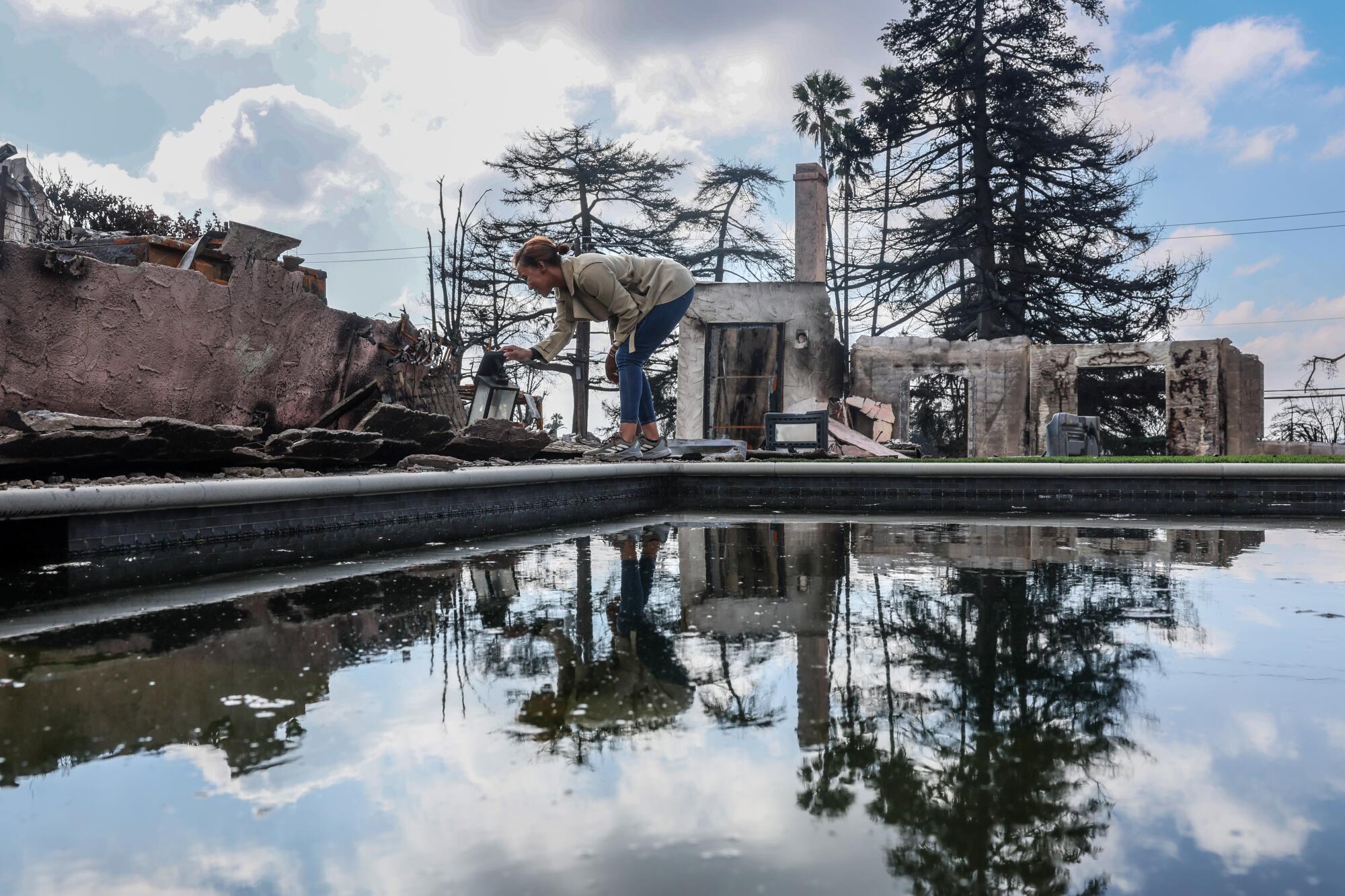  Jana Karibyna in the backyard of her home after it was destroyed by the Eaton fire.