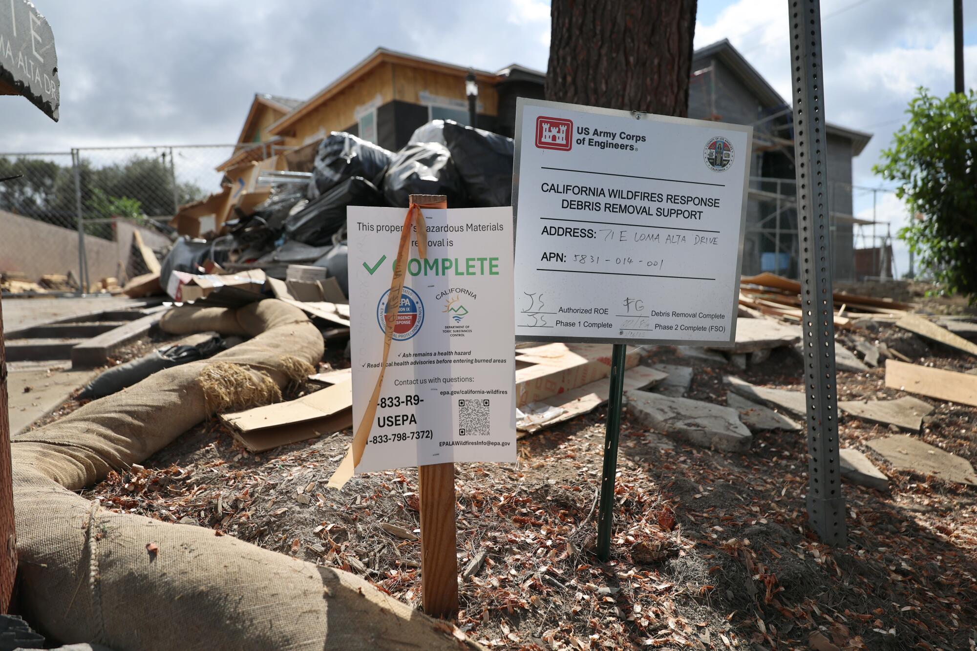 Signs are posted as construction is underway on the home of Carlos Lopez in Altadena.