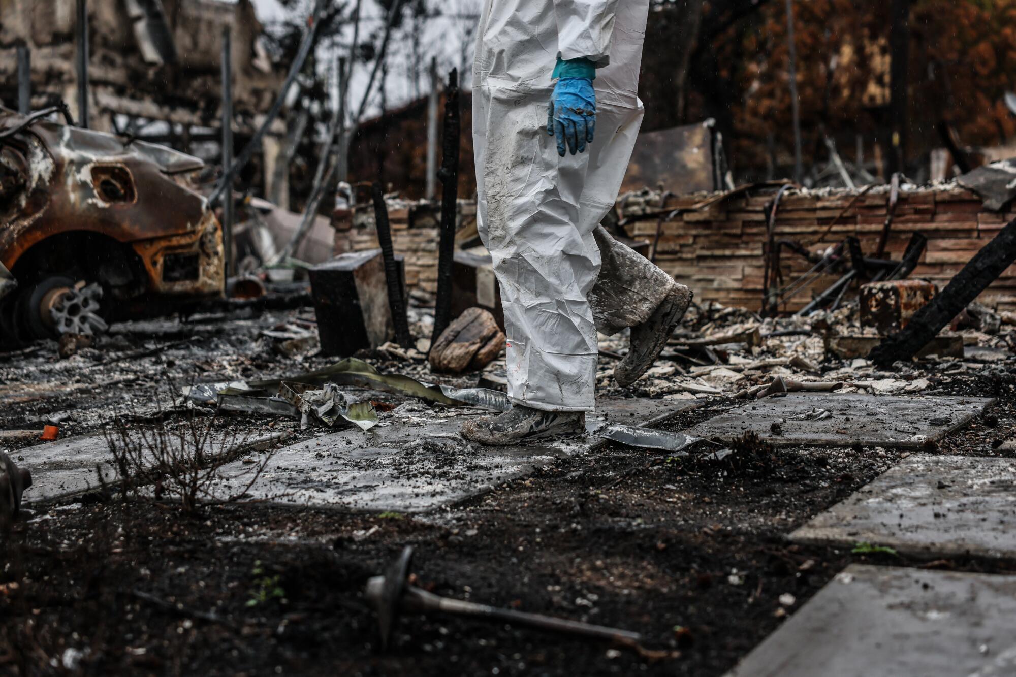 EPA crews comb the ruins of a home on Miami Way that was burned in the Palisades fire.