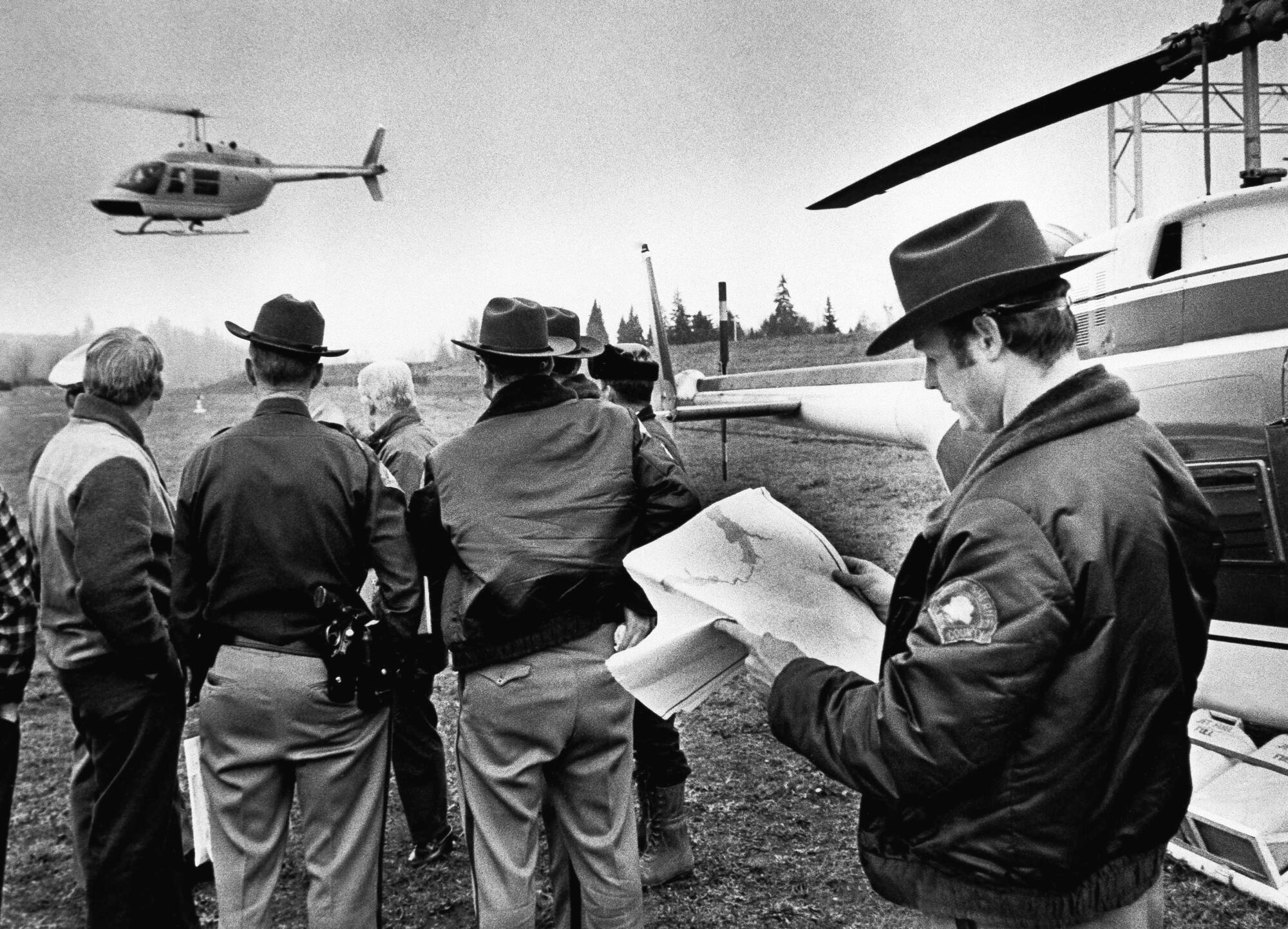 A helicopter takes off from search headquarters to scour the area where hijacker Dan Cooper might have parachuted.