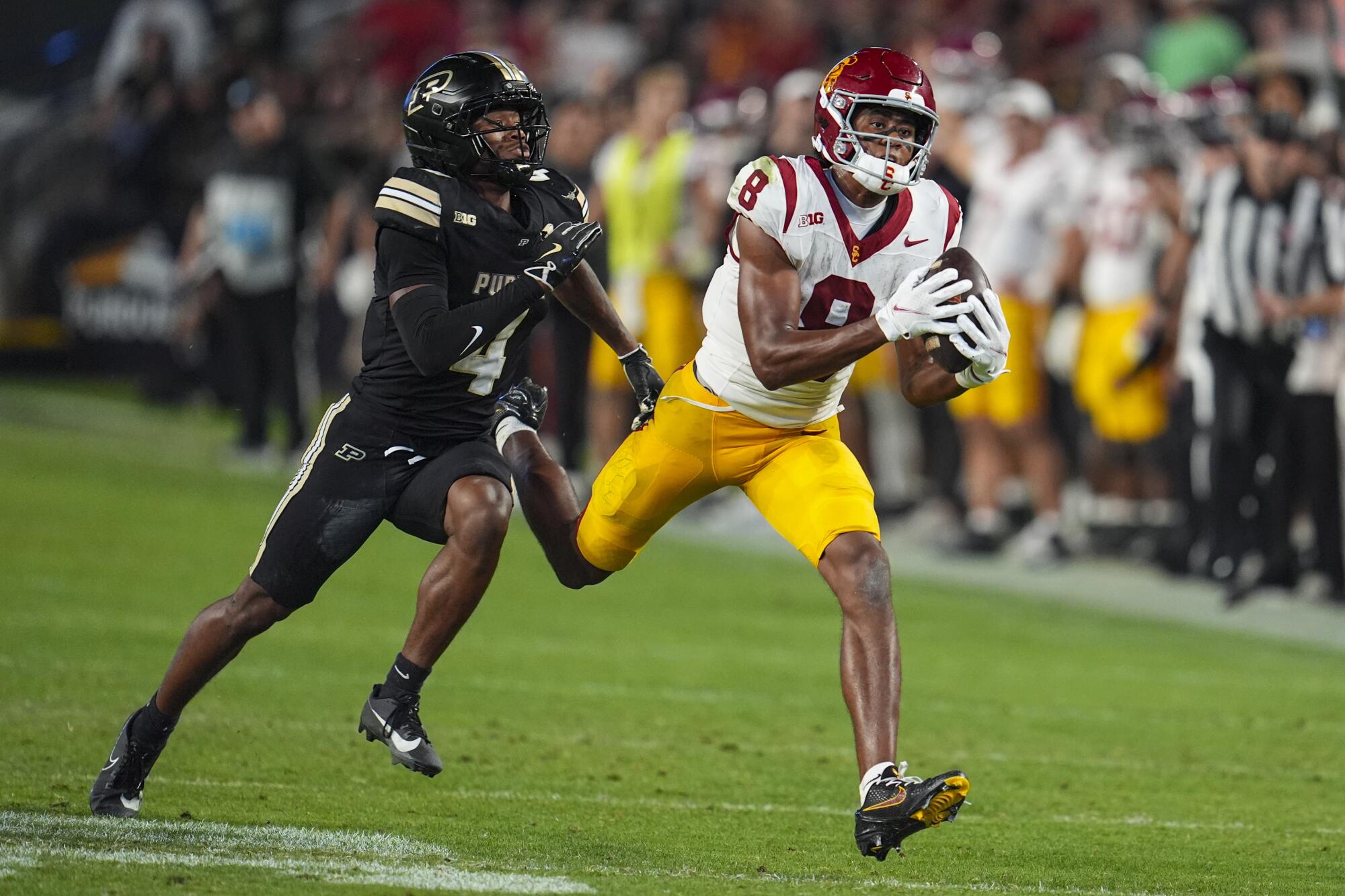 USC wide receiver Ja'Kobi Lane makes a catch in front of Purdue defensive back Hudauri Hines.