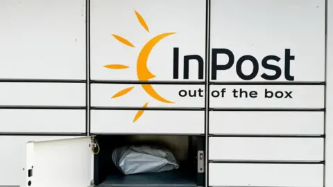 Getty Images An InPost locker unite with one door open. The open locker has a parcel inside.