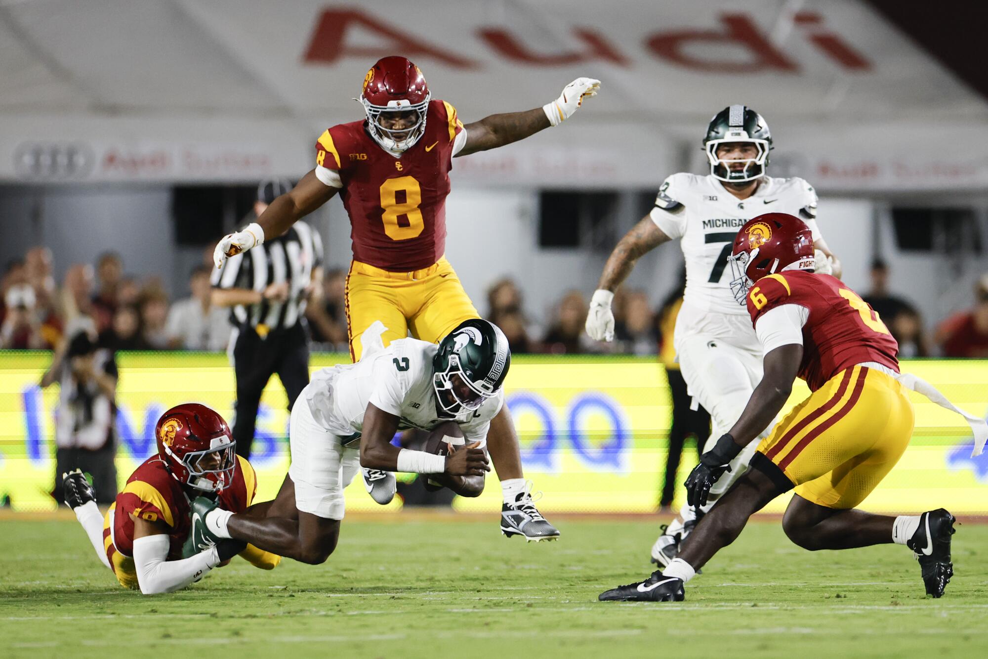 USC defensive end Braylan Shelby sacks Michigan State quarterback Aidan Chiles at the Coliseum on Saturday.