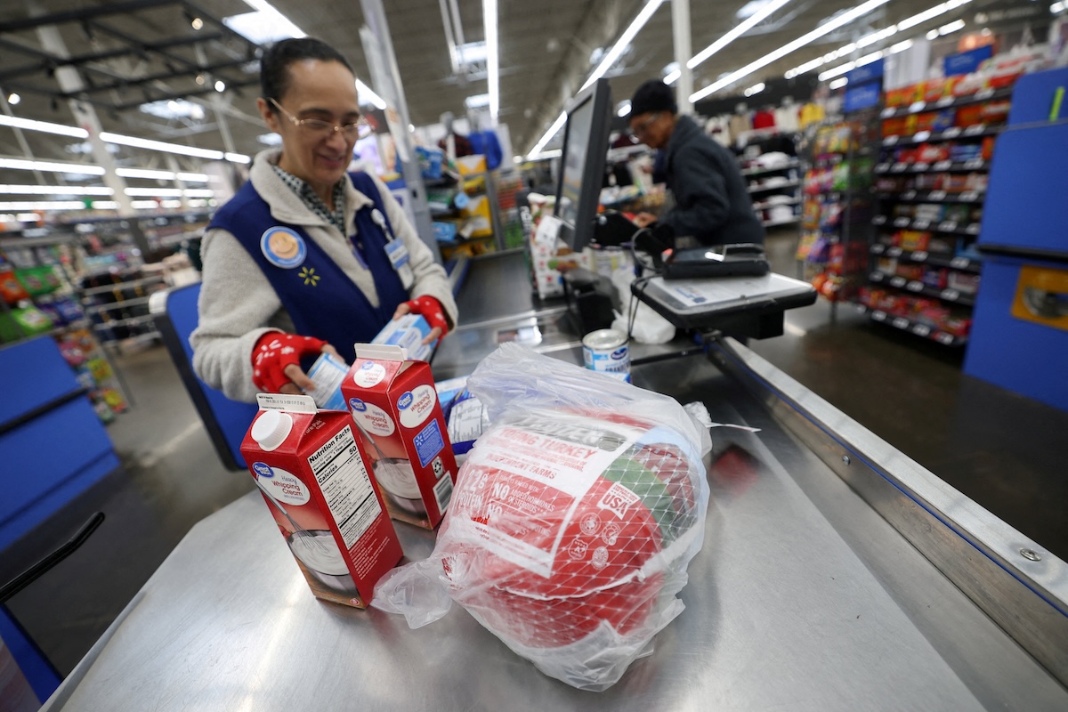 FILE PHOTO: Cashier loads a turkey and other groceries for checkout at Walmart Supercenter retail store in North Bergen, New Jersey
